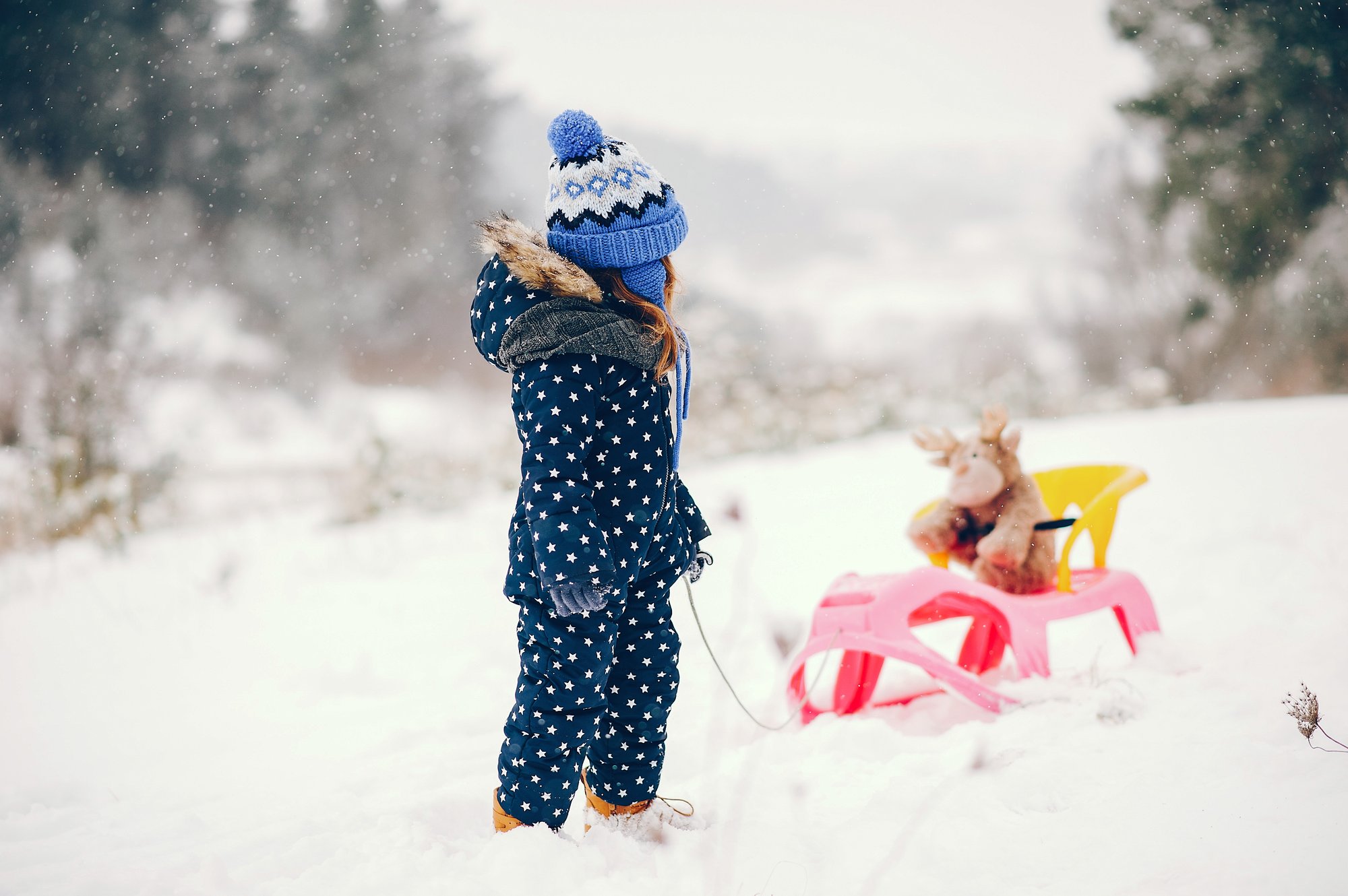 little-girl-blue-hat-playing-winter-forest